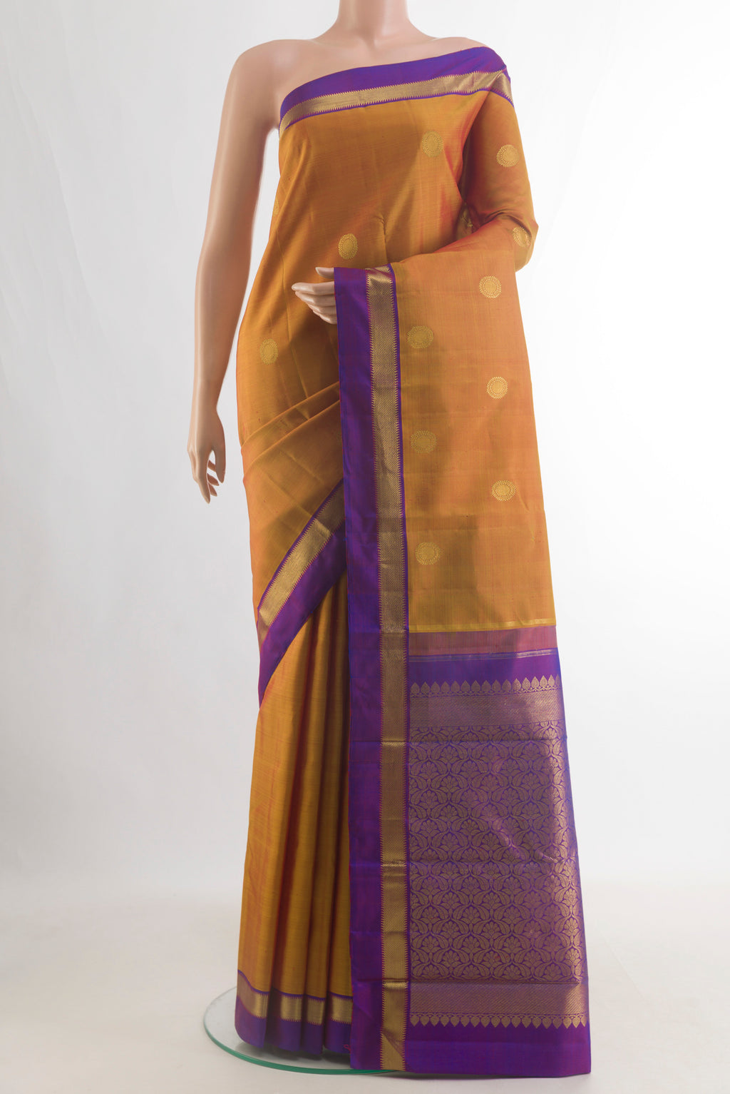 Pure Silk Mustard Kanchipuram Saree with Zari Butta on the body and Zari Border.  displayed on a mannequin