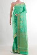 Pure Silk Green Kanjivaram Saree with Zari Butta on the body and Zari Border.  displayed on a mannequin