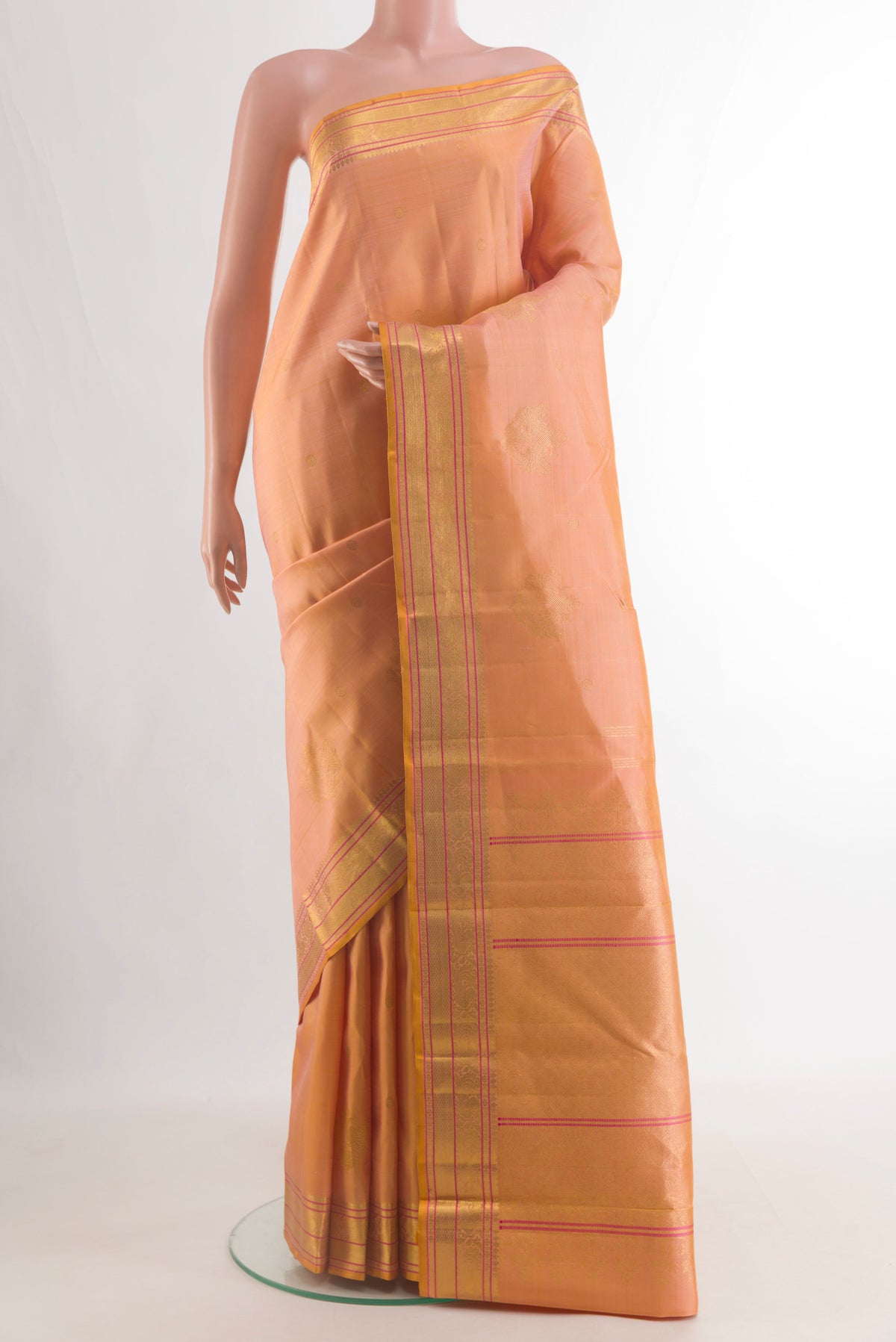 Pure Silk Orange Kanjivaram Saree with Zari Butta on the body and Zari Border.  displayed on a mannequin