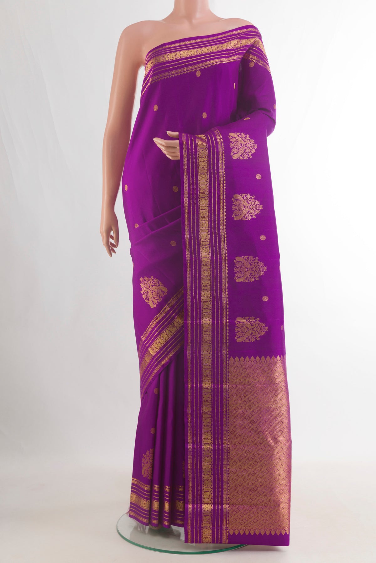 Pure Silk Purple Kanjivaram Saree with Zari Butta on the body and Zari Border.  displayed on a mannequin