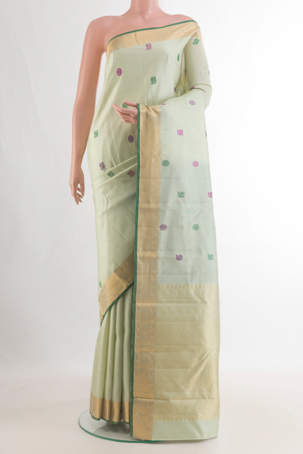 Pure Silk Mint Green Kanchipuram Saree with Thread Butta on the body and Zari Border.  displayed on a mannequin