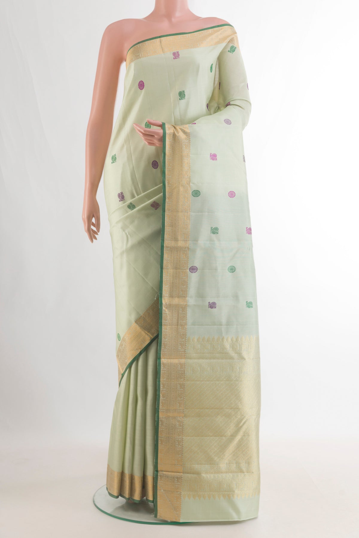 Pure Silk Mint Green Kanchipuram Saree with Thread Butta on the body and Zari Border.  displayed on a mannequin