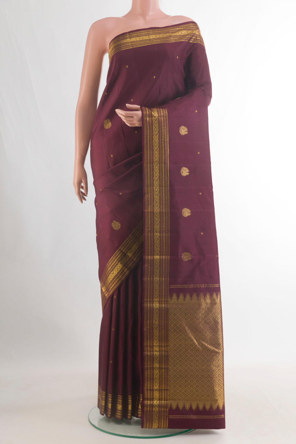 Pure Silk Coffee Brown Kanchipuram Saree with Zari Butta on the body and Zari Border.  displayed on a mannequin