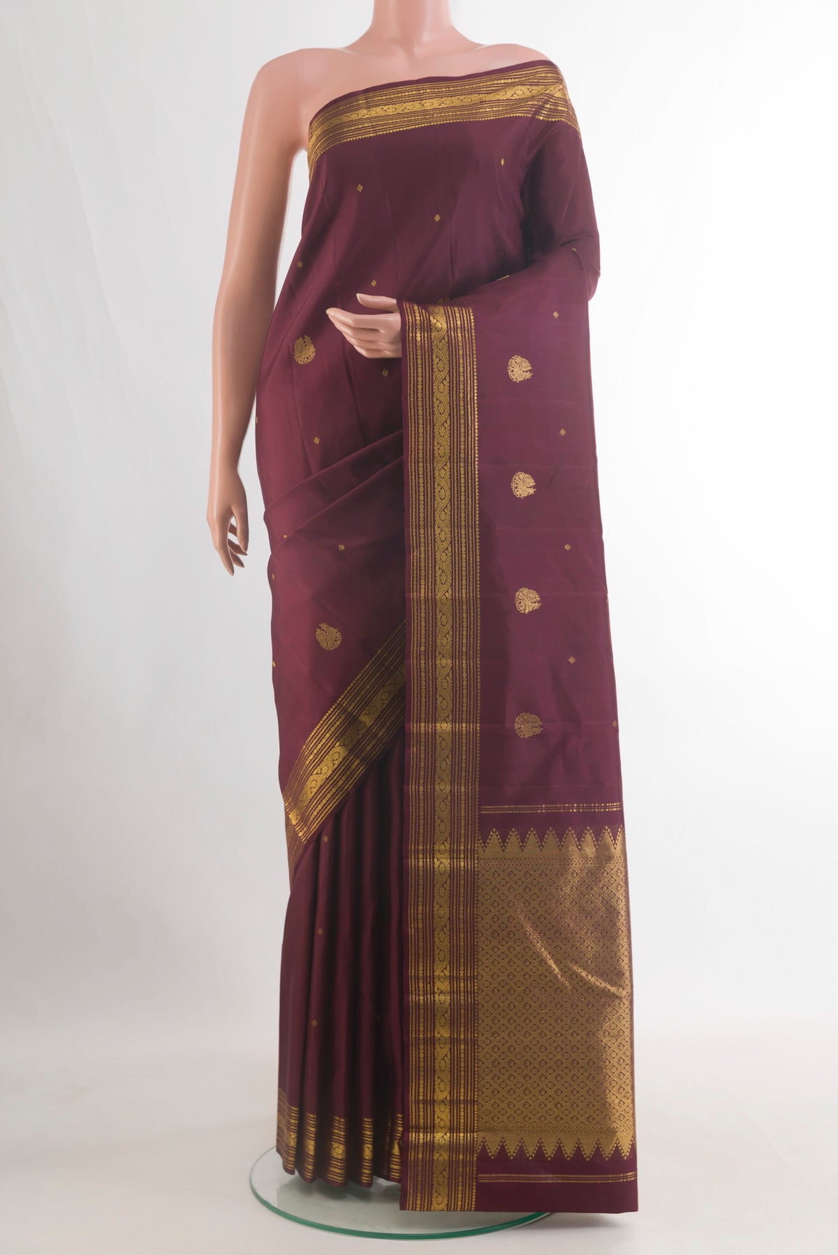Pure Silk Coffee Brown Kanchipuram Saree with Zari Butta on the body and Zari Border.  displayed on a mannequin