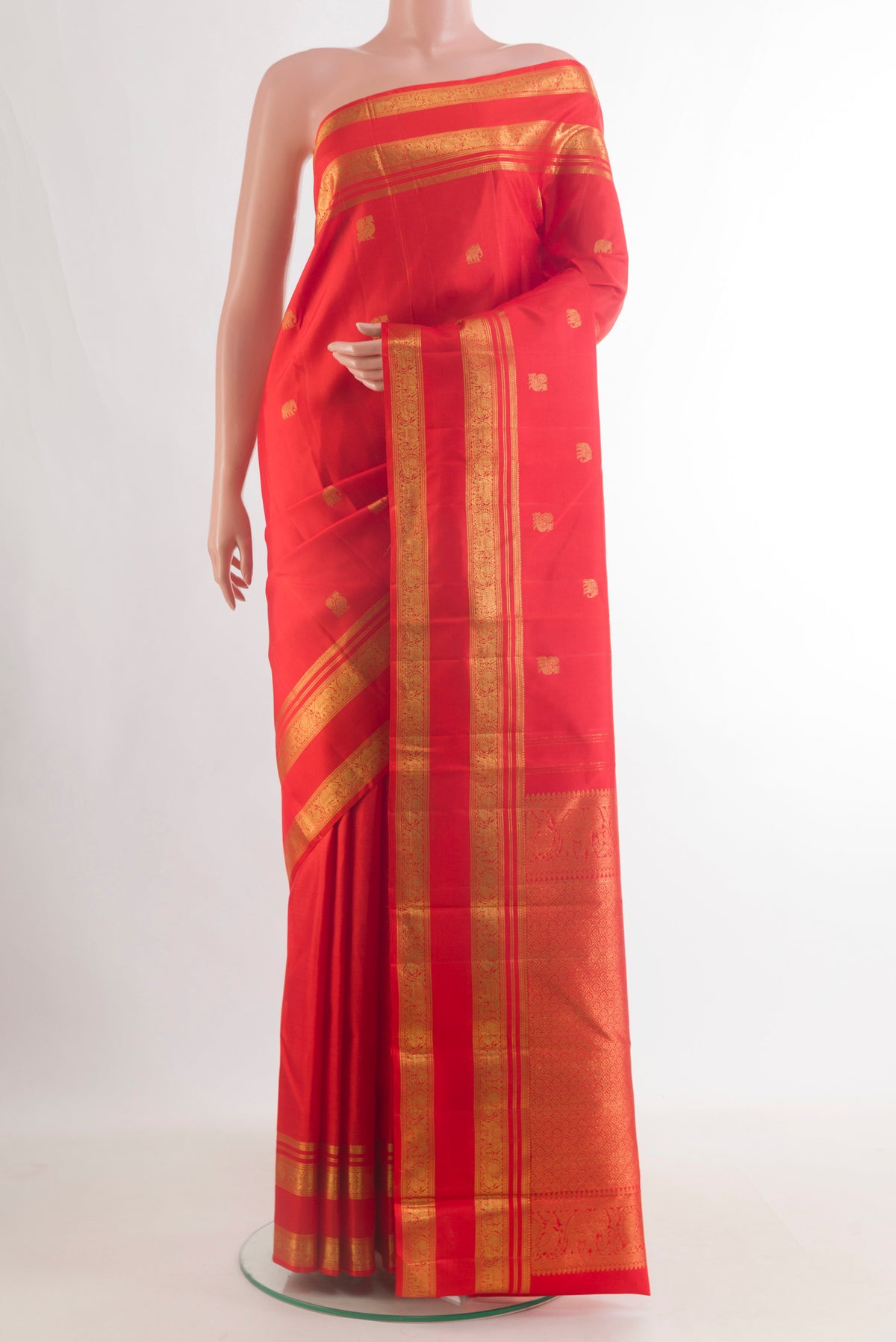 Pure Silk Red Kanchipuram Saree with Zari Butta on the body and Zari Border.  displayed on a mannequin