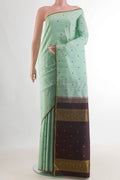 Pure Silk Mint Green Kanchipuram Saree with Thread Butta on the body and Zari Border.  displayed on a mannequin