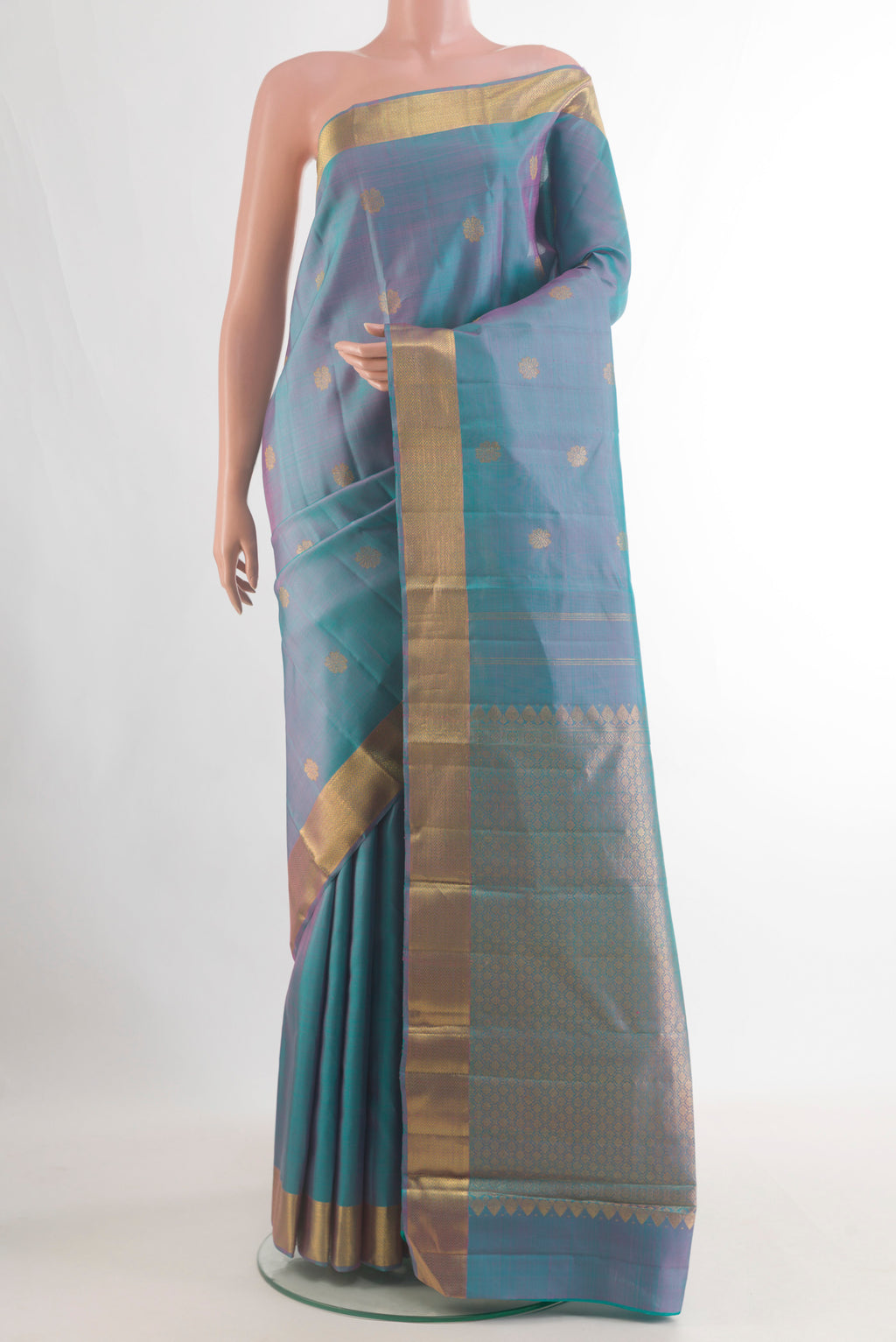 Pure Silk Teal Dual Tone Kanjivaram Saree with Zari Butta on the body and Zari Border.  displayed on a mannequin