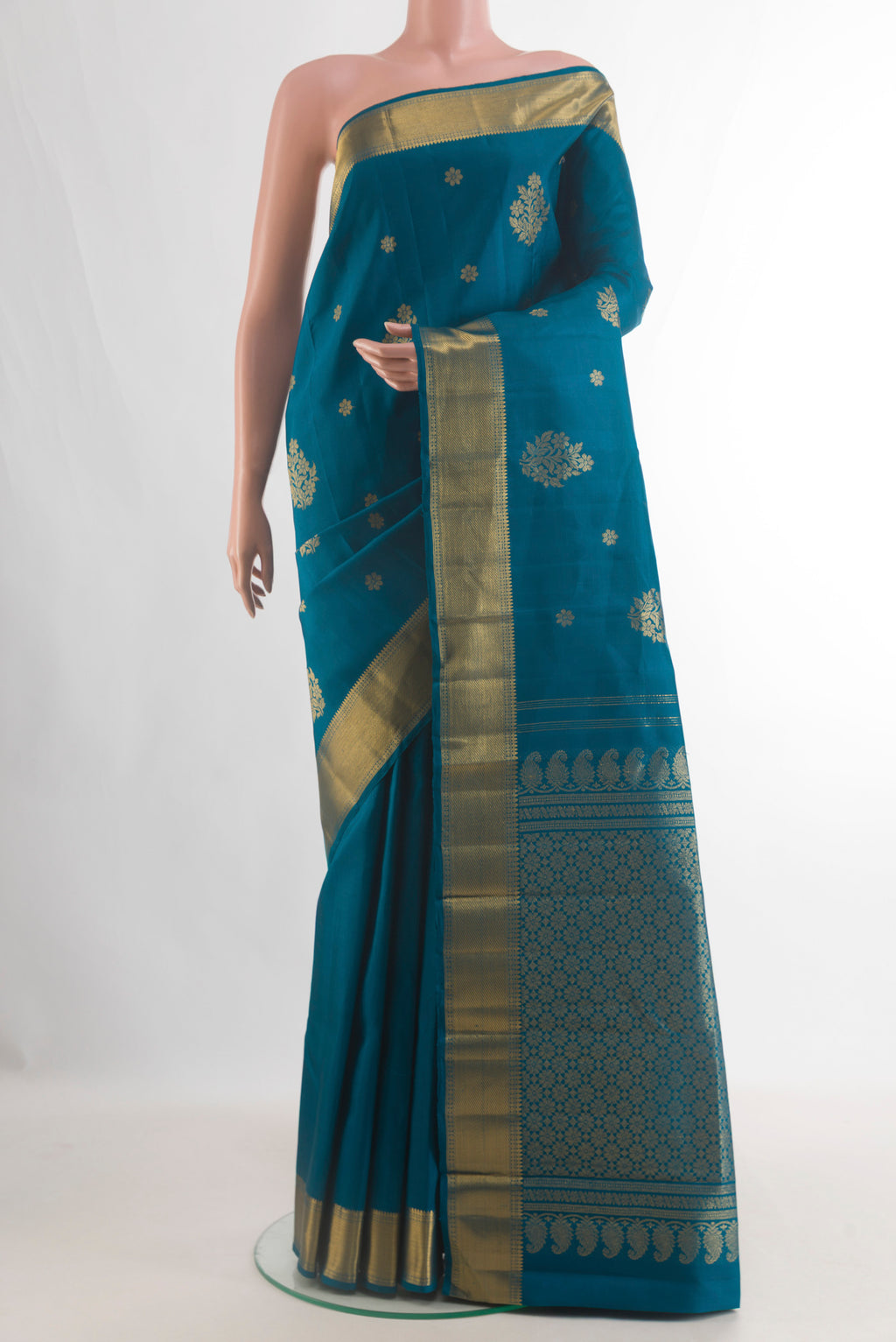 Pure Silk Blue Kanjivaram Saree with Zari Butta on the body and Zari Border.  displayed on a mannequin