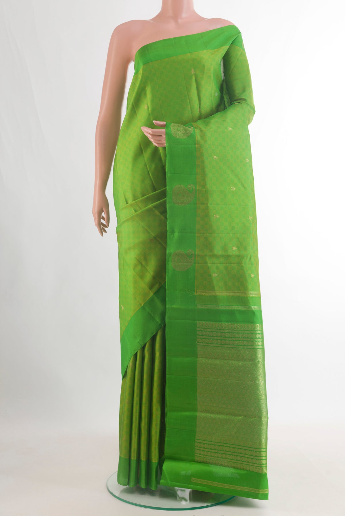 Pure Silk Parrot Green Kanchipuram Saree with Zari Butta on the body and Zari Border.  displayed on a mannequin