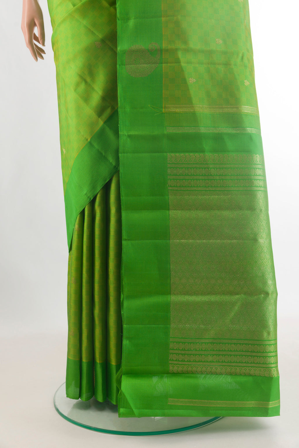 Pleats and pallu of Pure Silk Parrot Green Kanchipuram Saree with Zari Butta on the body and Zari Border. 