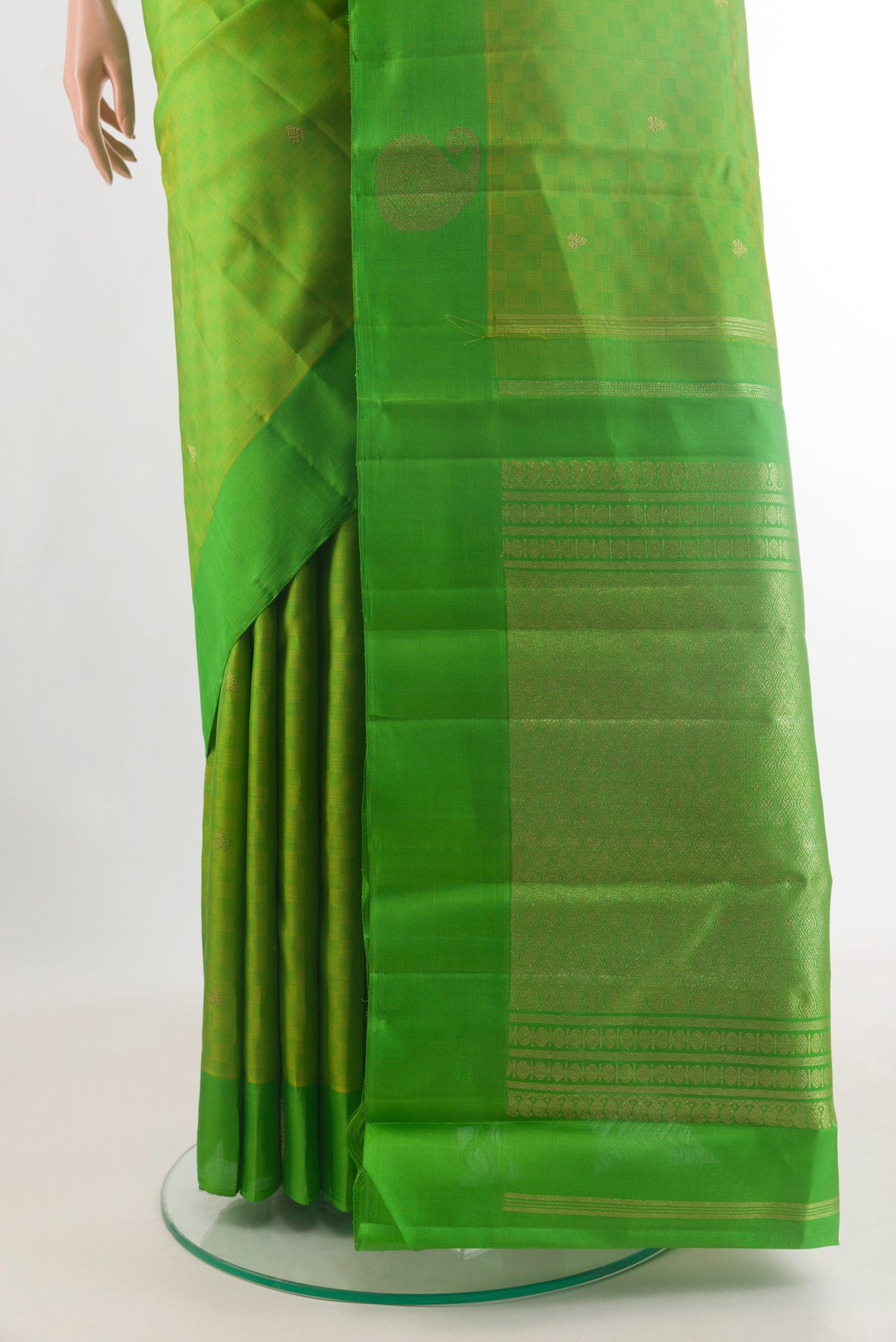 Pleats and pallu of Pure Silk Parrot Green Kanchipuram Saree with Zari Butta on the body and Zari Border. 