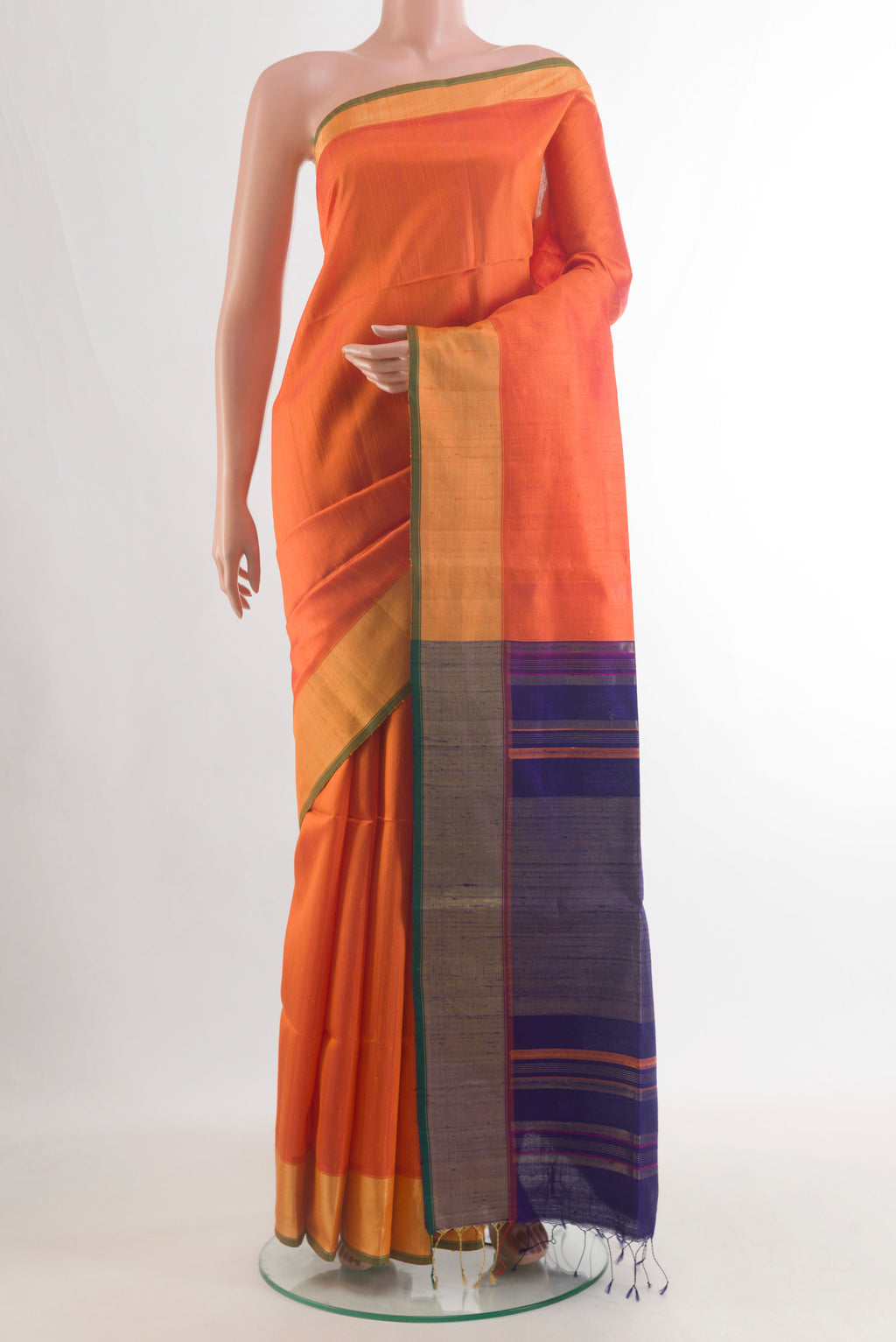 Pure Silk Orange Soft Saree with Plain Body and Zari Border.  displayed on a mannequin