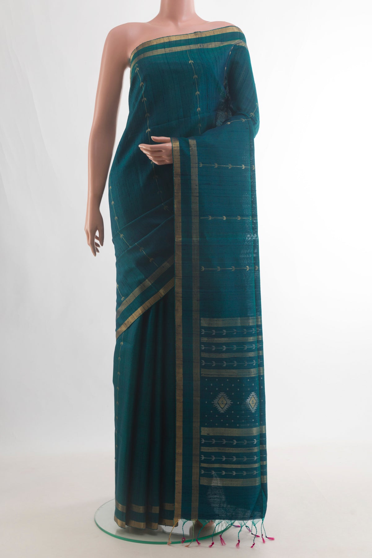 Pure Silk Teal Raw Saree with Zari Butta on the body and Zari Border.  displayed on a mannequin