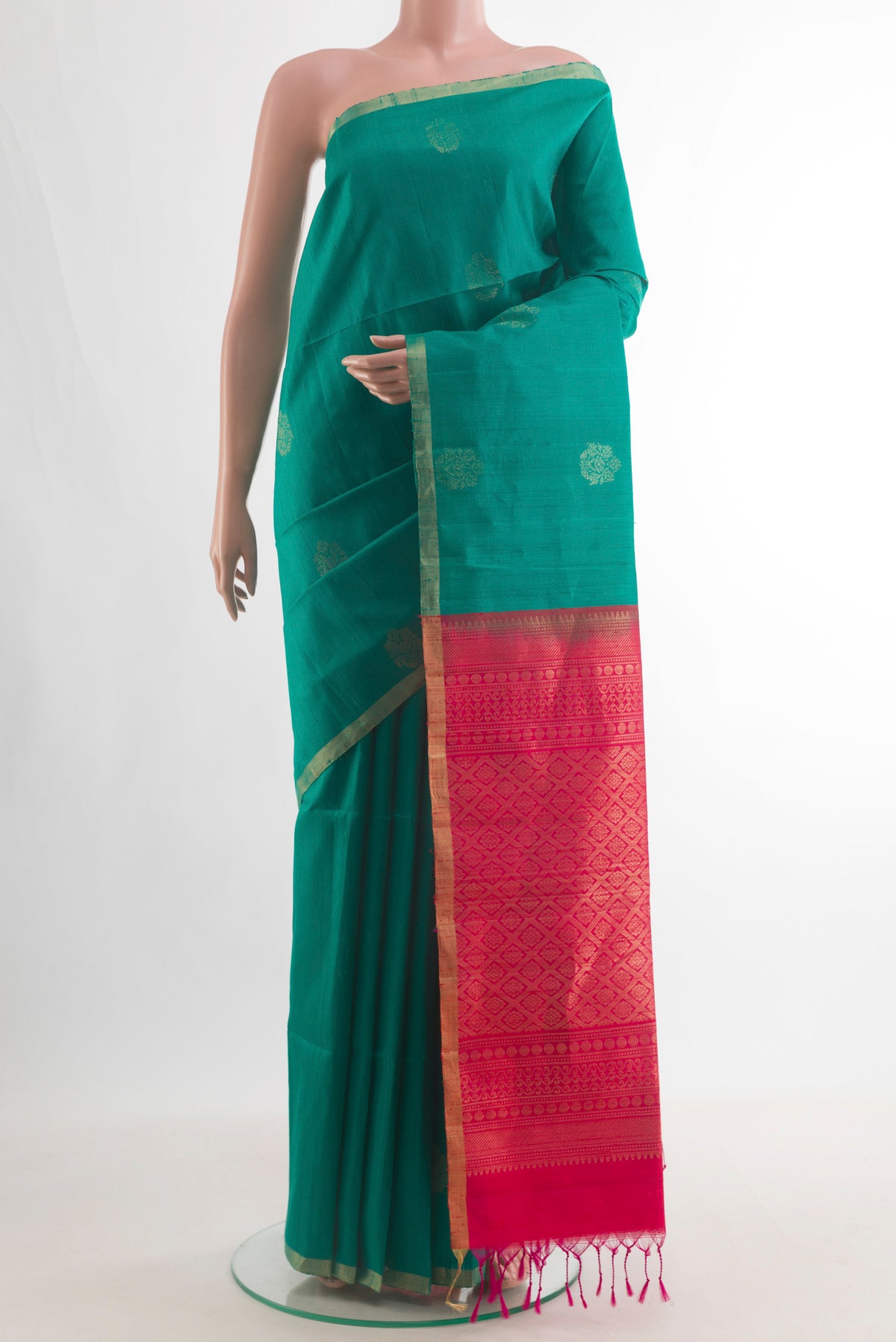 Pure Silk Sea Green Raw Saree with Zari Butta on the body and Zari Border.  displayed on a mannequin