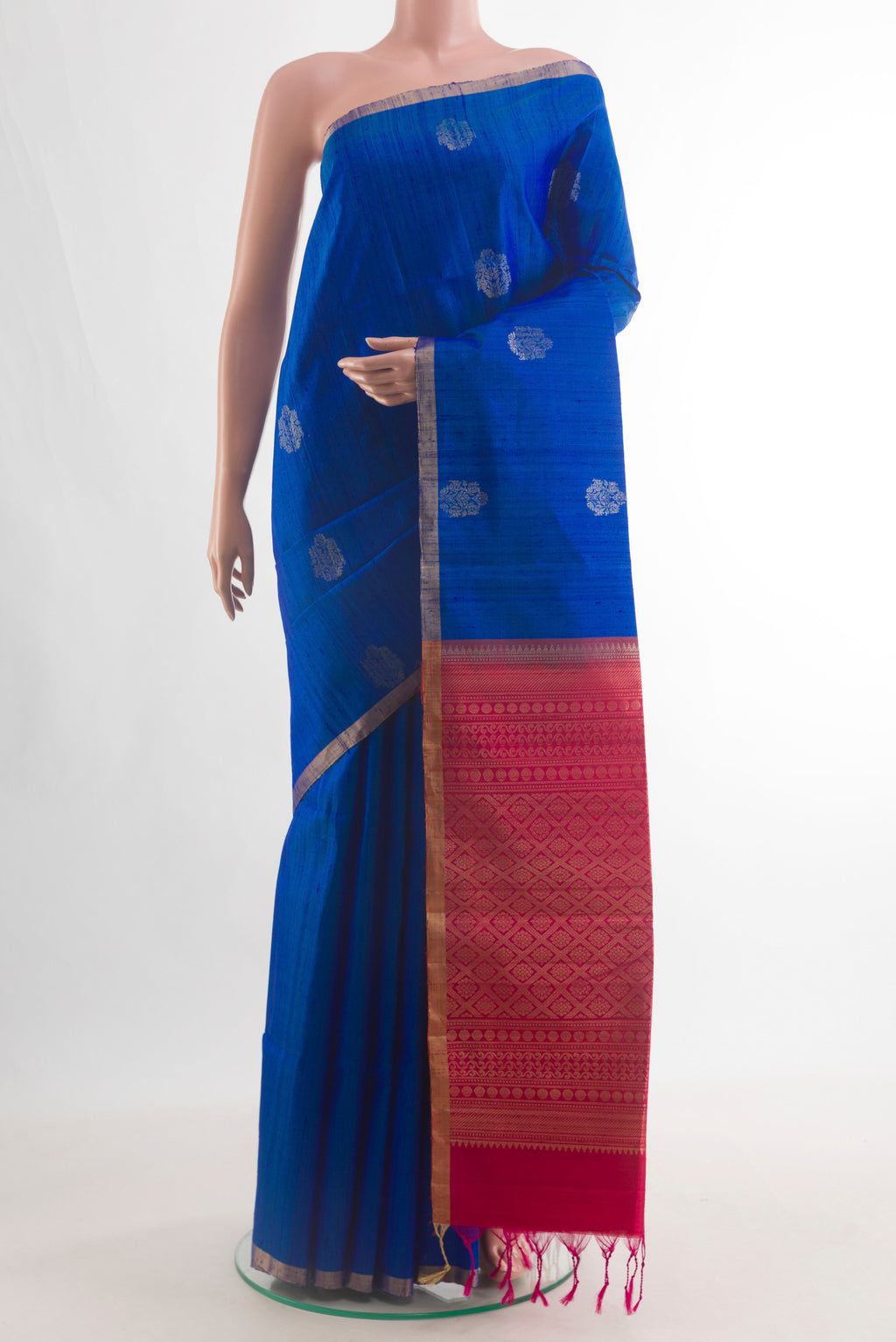 Pure Silk Blue Raw Saree with Zari Butta on the body and Zari Border.  displayed on a mannequin