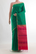 Pure Silk Green Raw Saree with Thread Butta on the body and Zari Border.  displayed on a mannequin