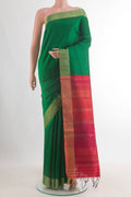 Pure Silk Green Raw Saree with Plain Body and Zari Border.  displayed on a mannequin