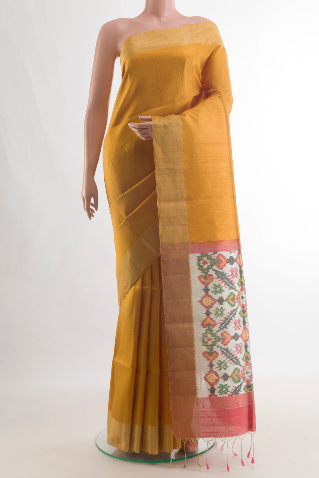 Pure Silk Mustard Raw Saree with Plain Body and Zari Border.  displayed on a mannequin