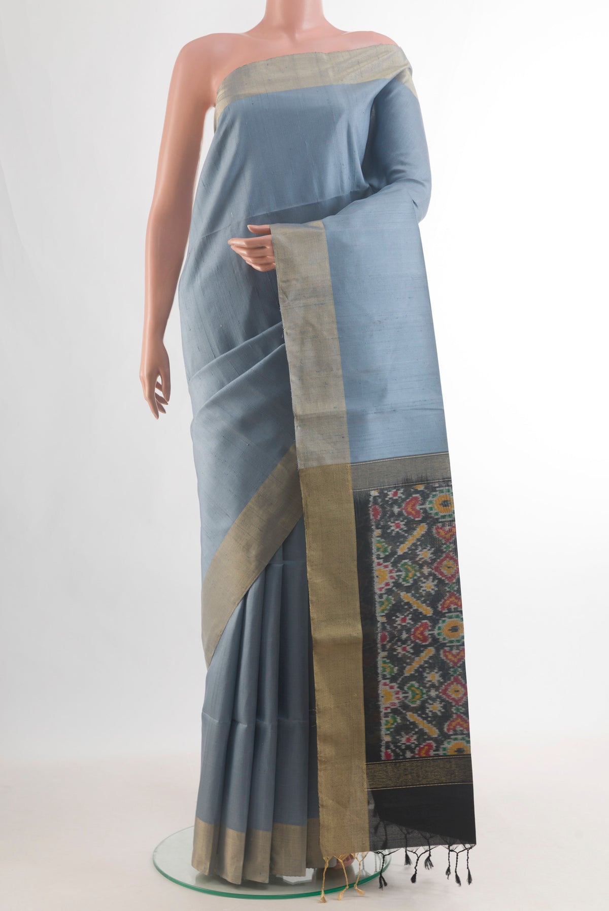 Pure Silk Grey Raw Saree with Plain Body and Zari Border.  displayed on a mannequin