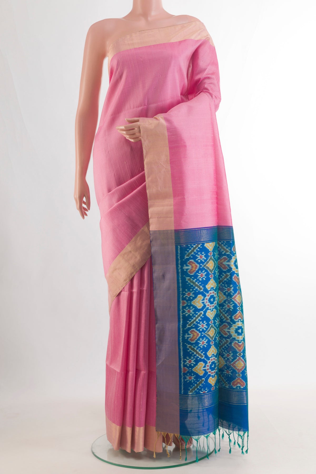 Pure Silk Pink Raw Saree with Plain Body and Zari Border.  displayed on a mannequin