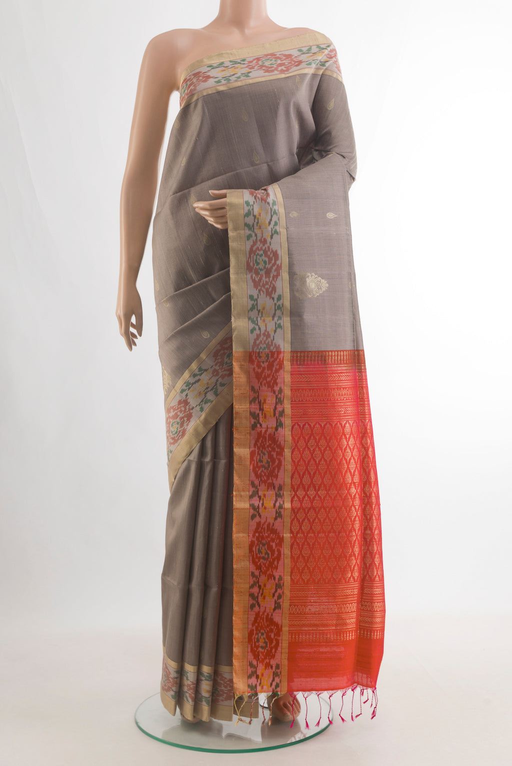 Pure Silk Grey Raw Saree with Zari Butta on the body and Ikat Border.  displayed on a mannequin
