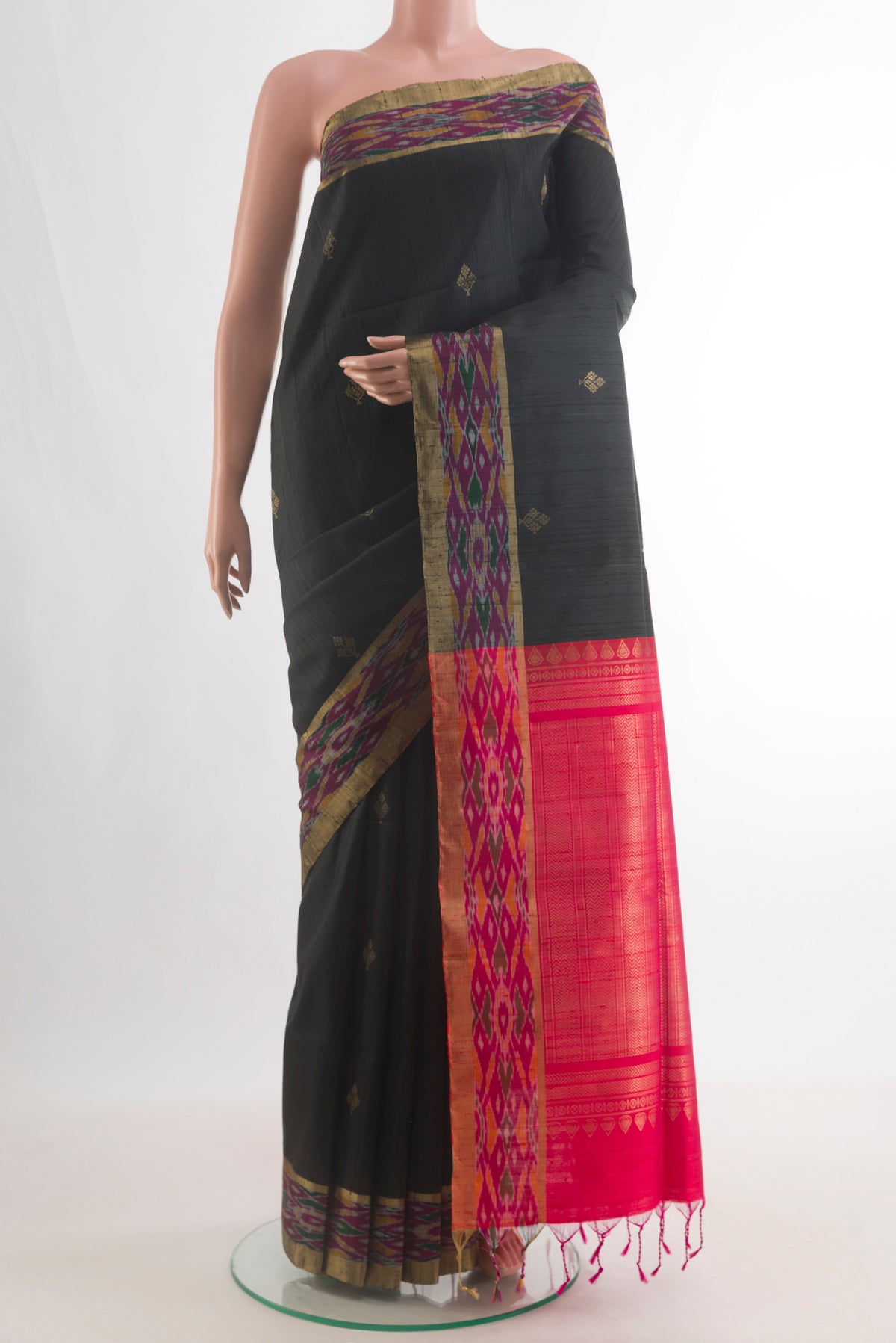 Pure Silk Black Raw Saree with Zari Butta on the body and Ikat Border.  displayed on a mannequin