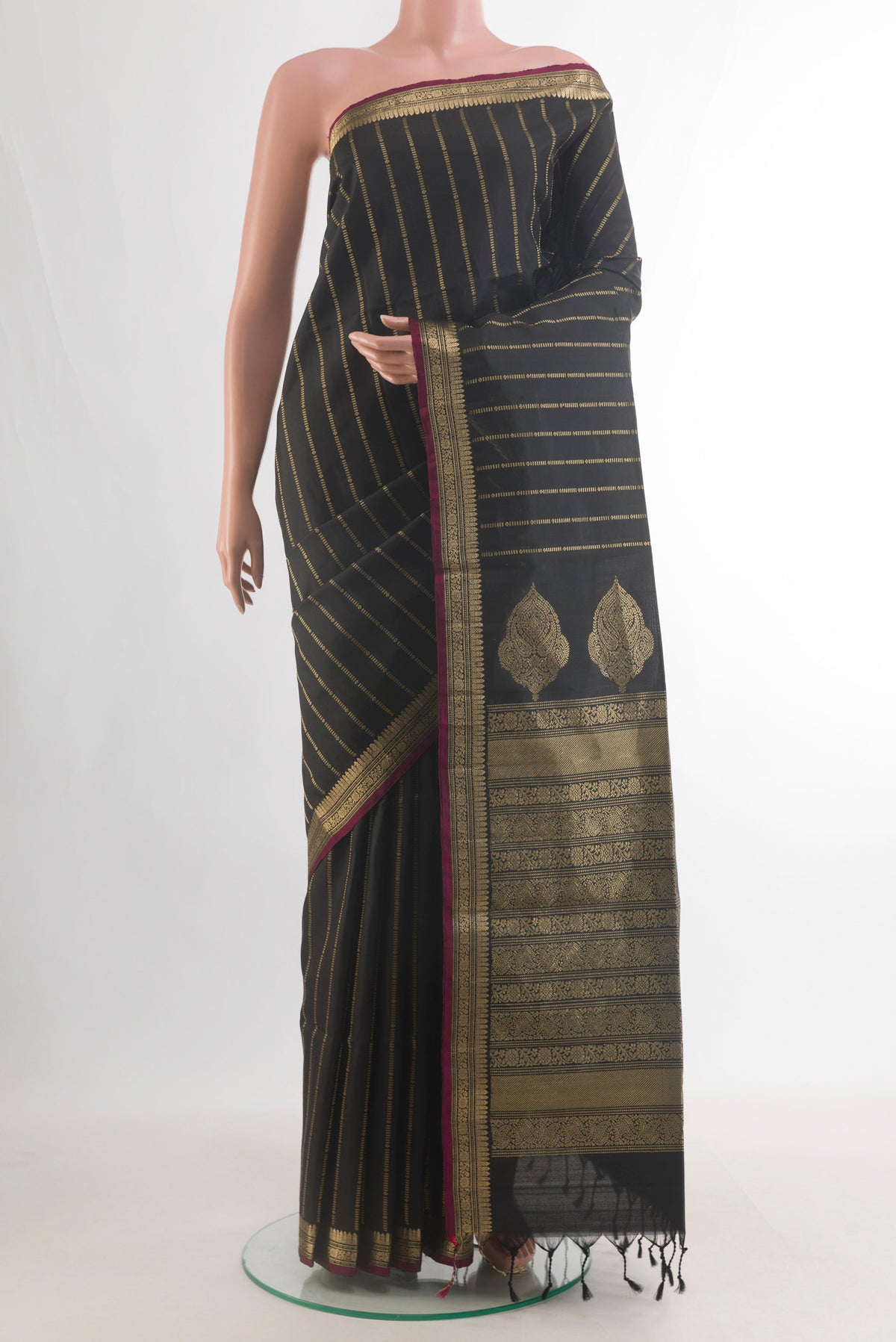 Pure Silk Black Soft Saree with Stripes on the body and Zari Border.  displayed on a mannequin
