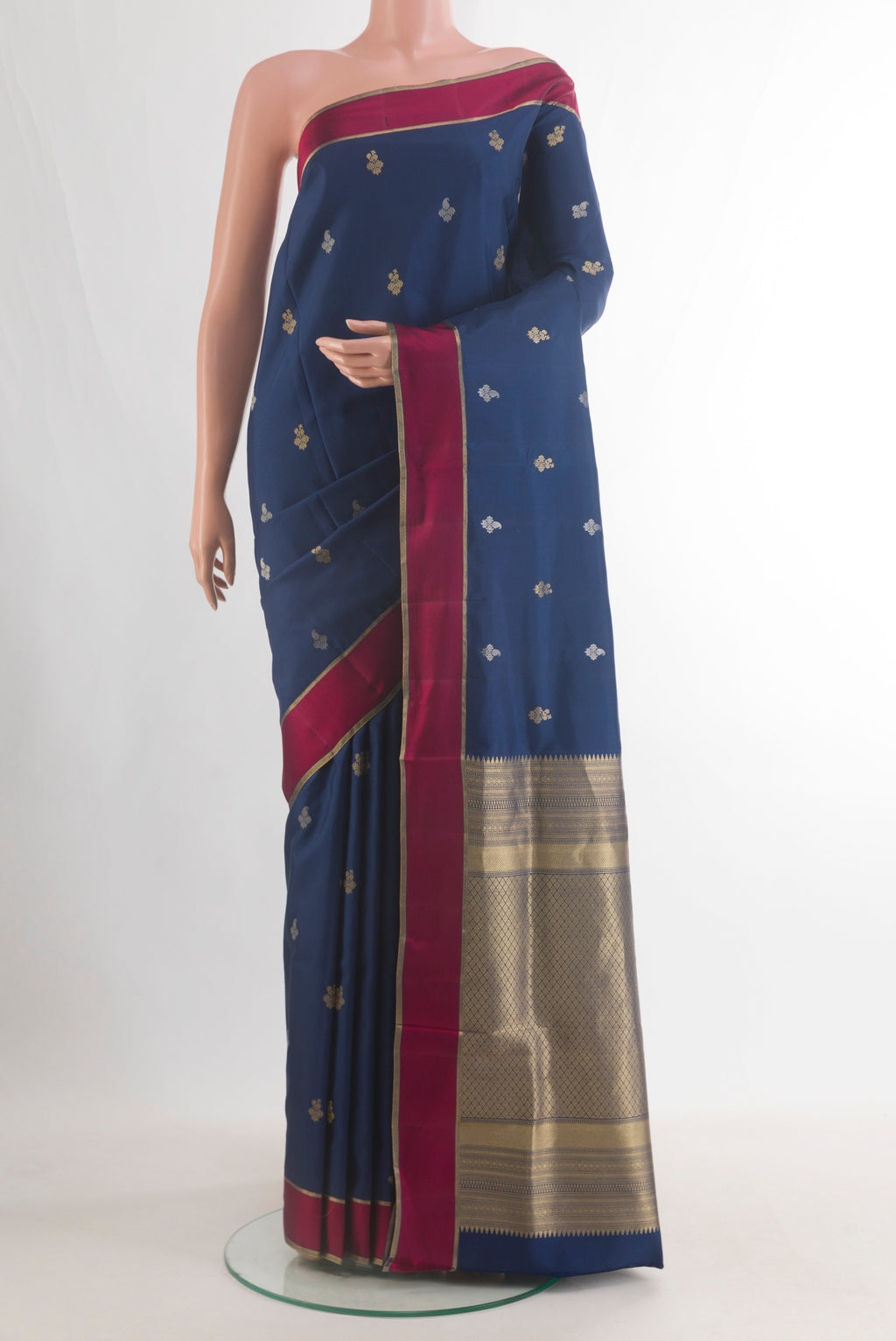 Pure Silk Navy Blue Soft Saree with Zari Butta on the body and Zari Border.  displayed on a mannequin