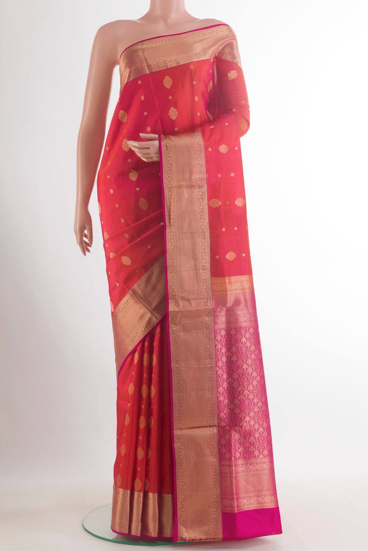 Pure Silk Orange Soft Saree with Zari Butta on the body and Zari Border.  displayed on a mannequin