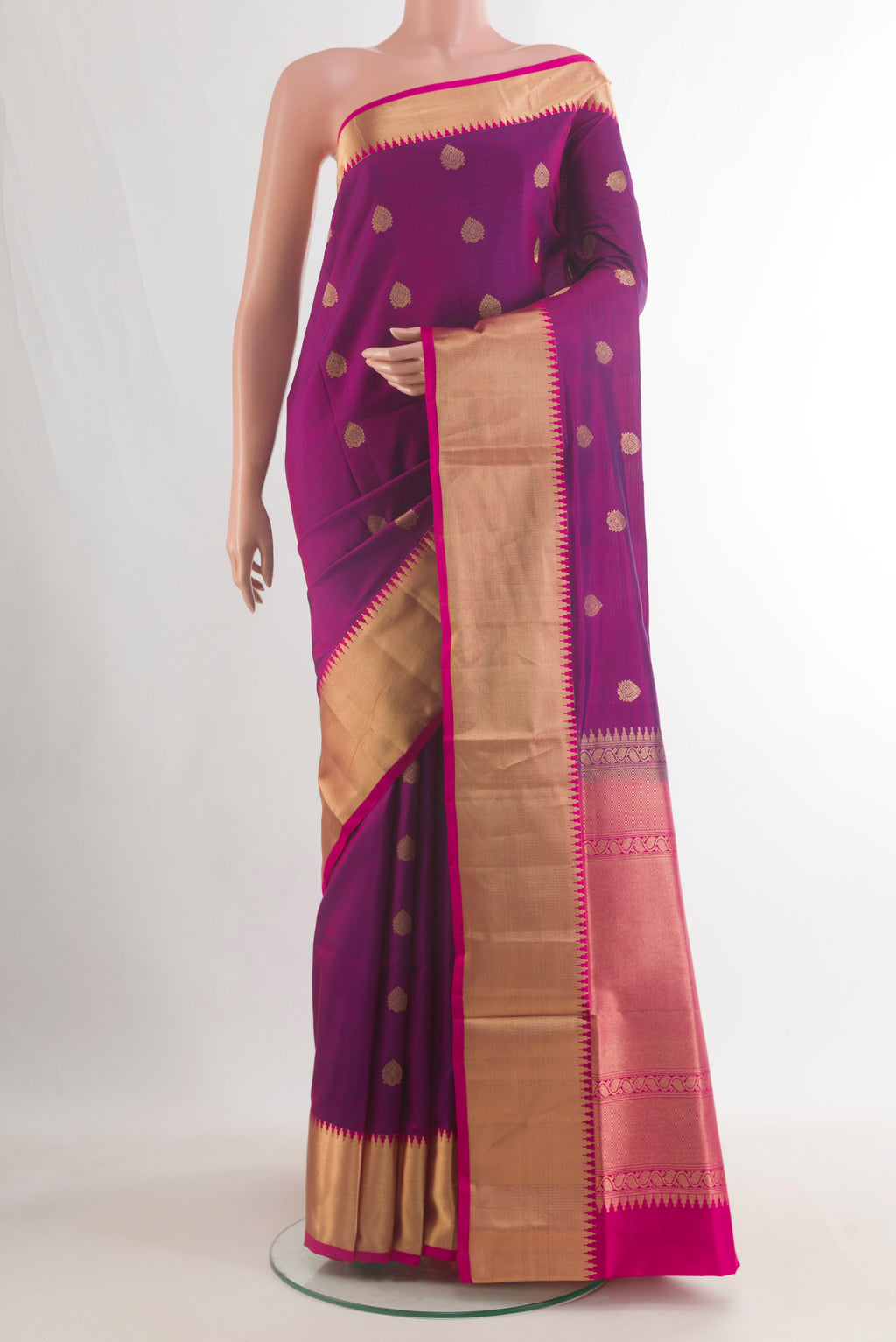 Pure Silk Magenta Soft Saree with Zari Butta on the body and Zari Border.  displayed on a mannequin