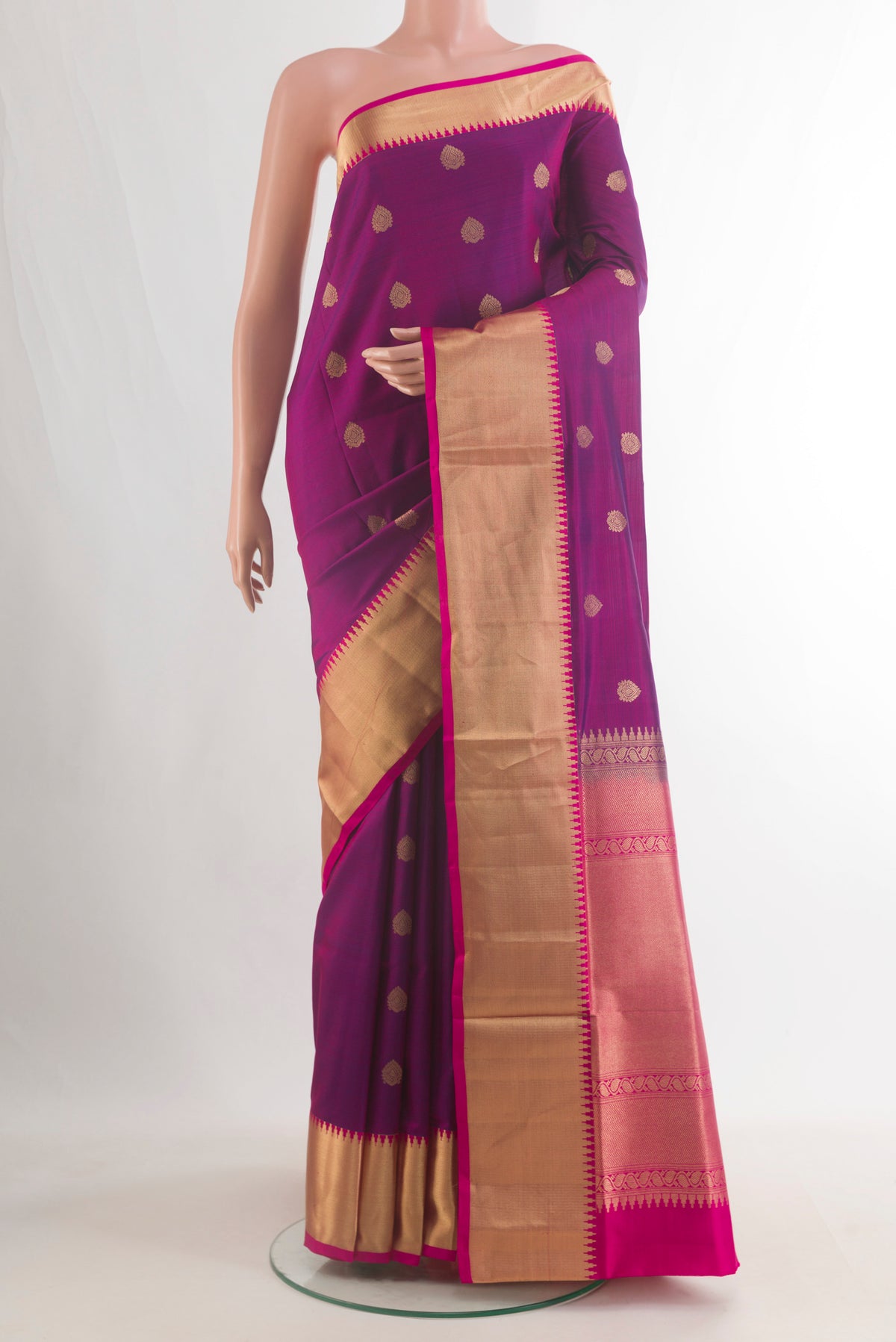 Pure Silk Magenta Soft Saree with Zari Butta on the body and Zari Border.  displayed on a mannequin