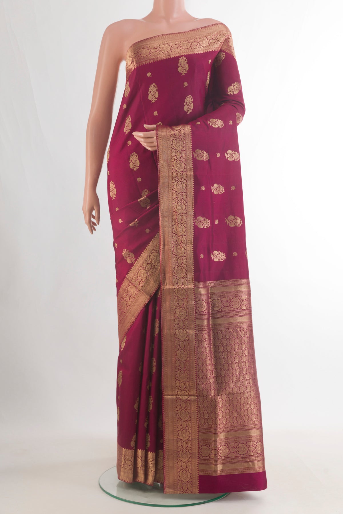 Pure Silk Maroon Soft Saree with Zari Butta on the body and Zari Border.  displayed on a mannequin