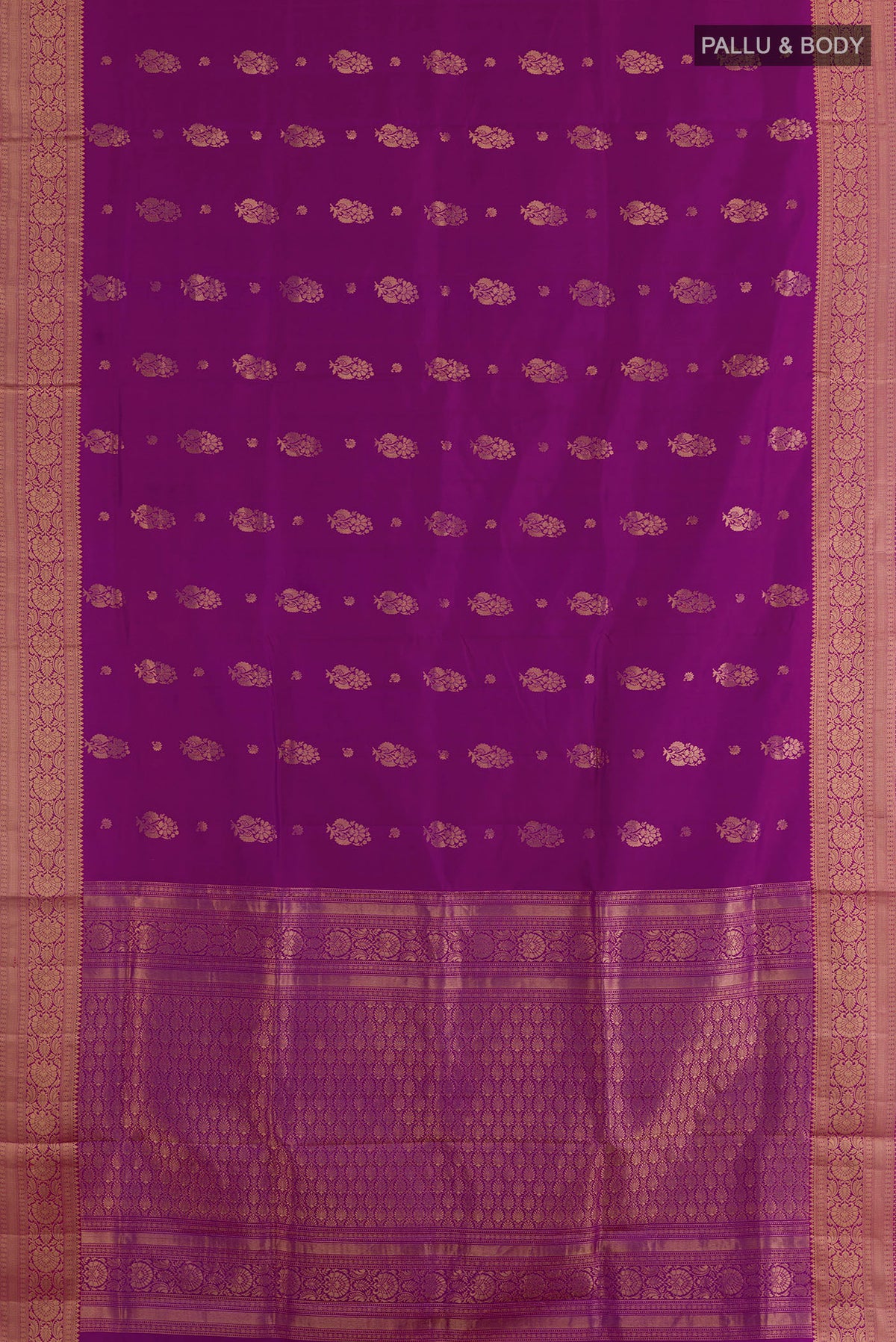 Flat view of Pure Silk Magenta Soft Saree with Zari Butta on the body and Zari Border. 