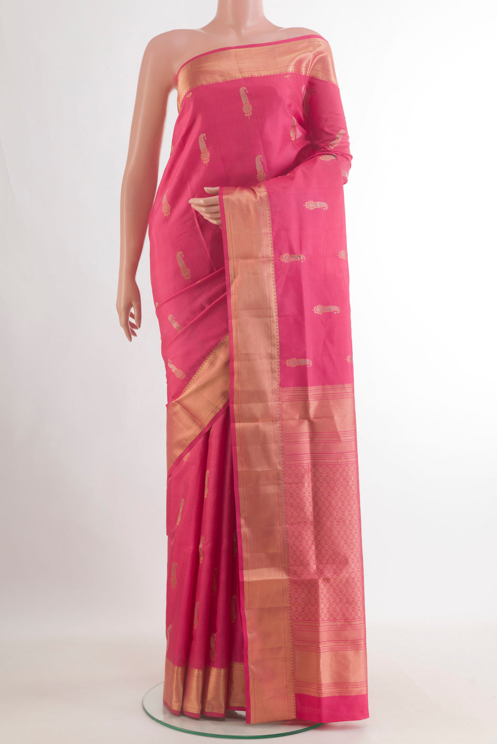 Pure Silk Coral Soft Saree with Zari Butta on the body and Zari Border.  displayed on a mannequin