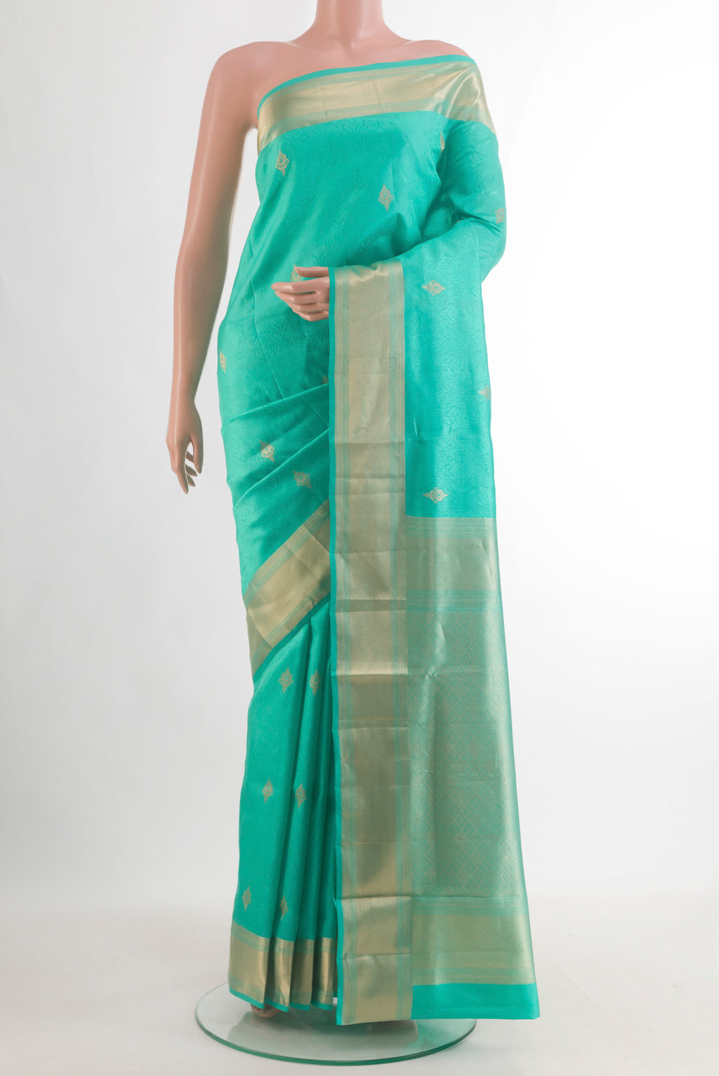 Pure Silk Sea Green Soft Saree with Jacquard With Zari Butta on the body and Zari Border.  displayed on a mannequin