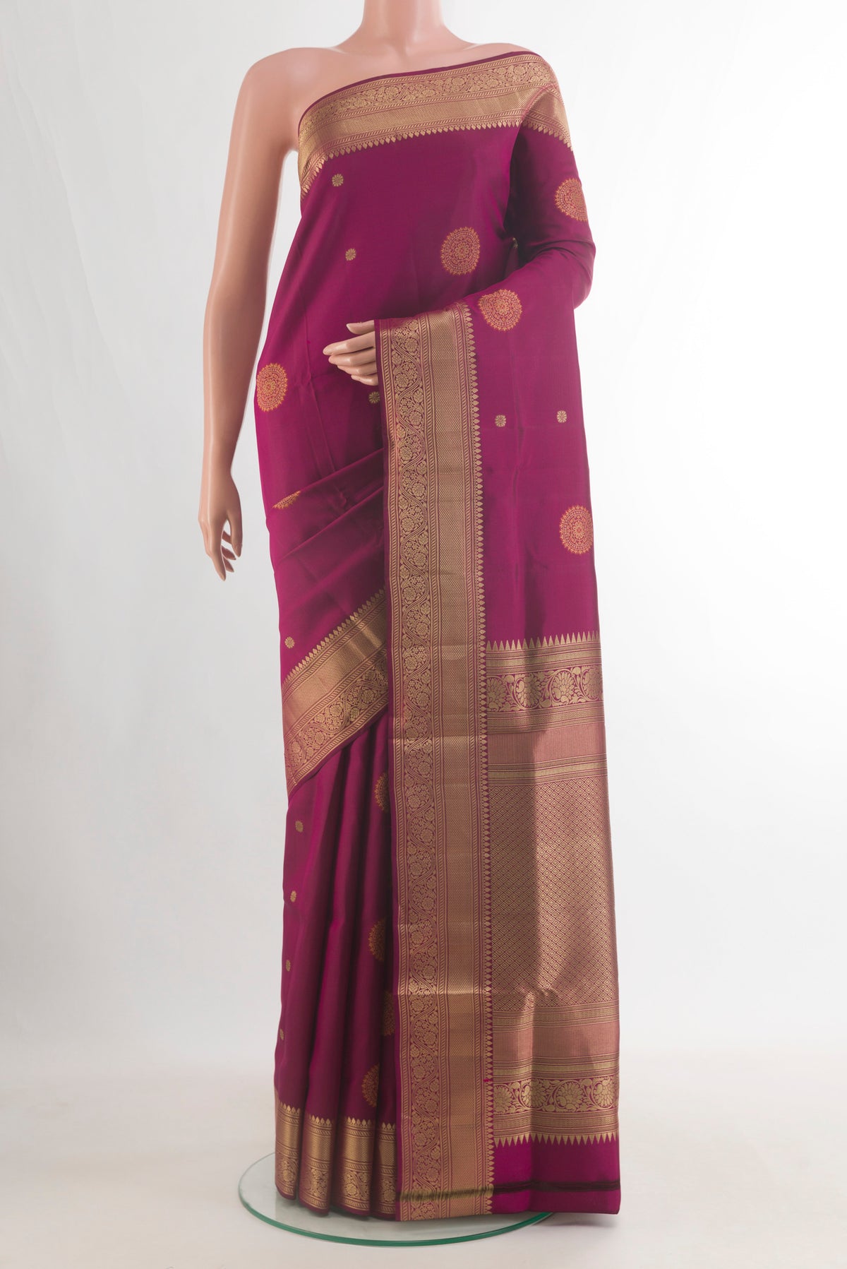 Pure Silk Magenta Soft Saree with Zari Butta on the body and Zari Border.  displayed on a mannequin