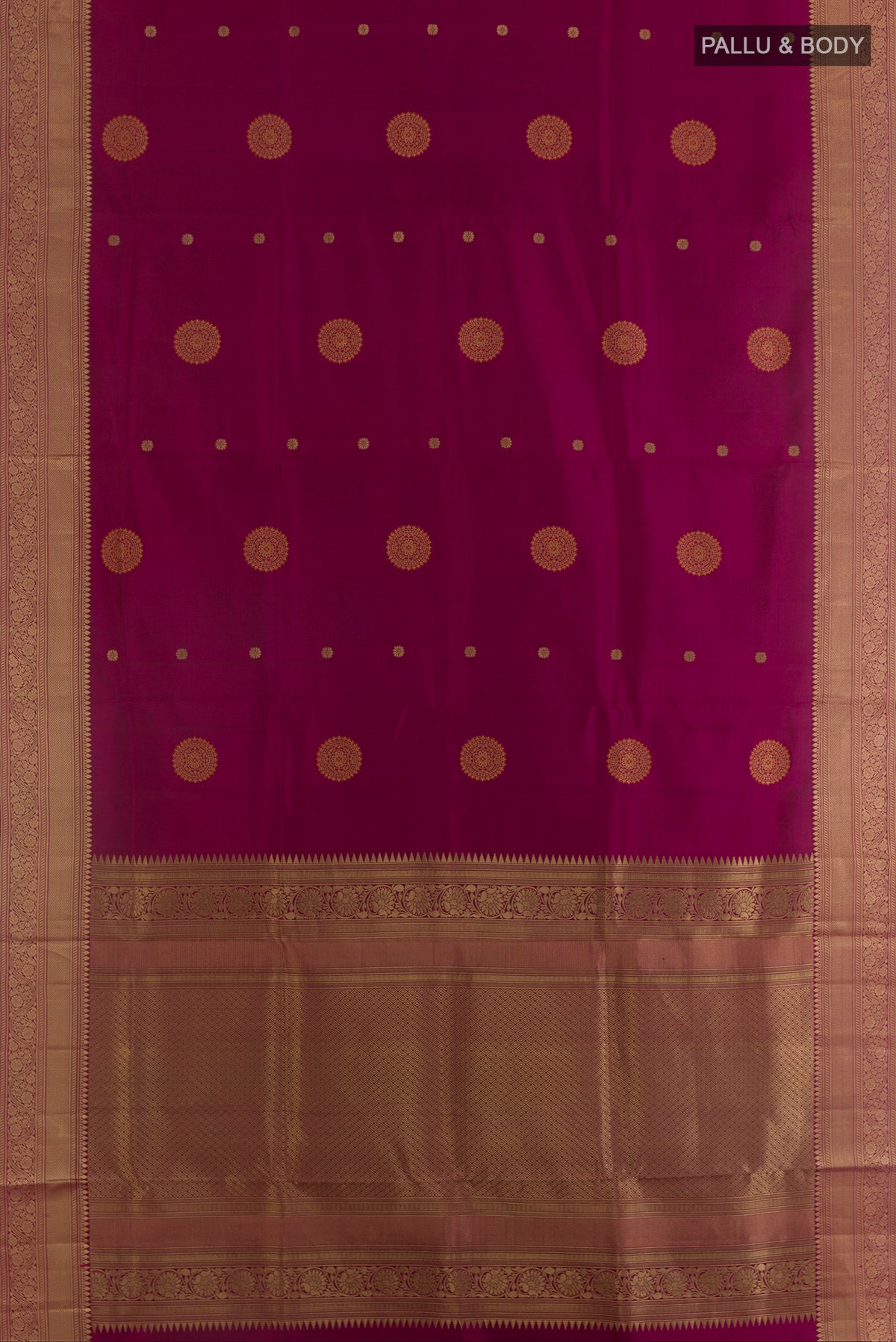 Flat view of Pure Silk Magenta Soft Saree with Zari Butta on the body and Zari Border. 