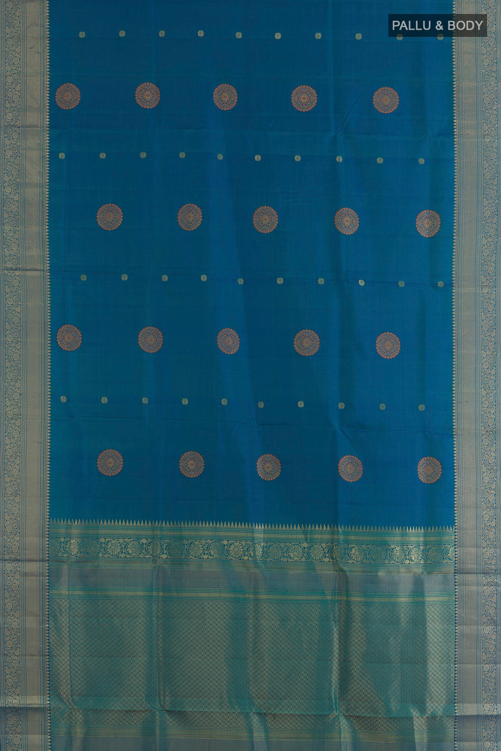 Flat view of Pure Silk Peacock Blue Soft Saree with Zari Butta on the body and Zari Border. 