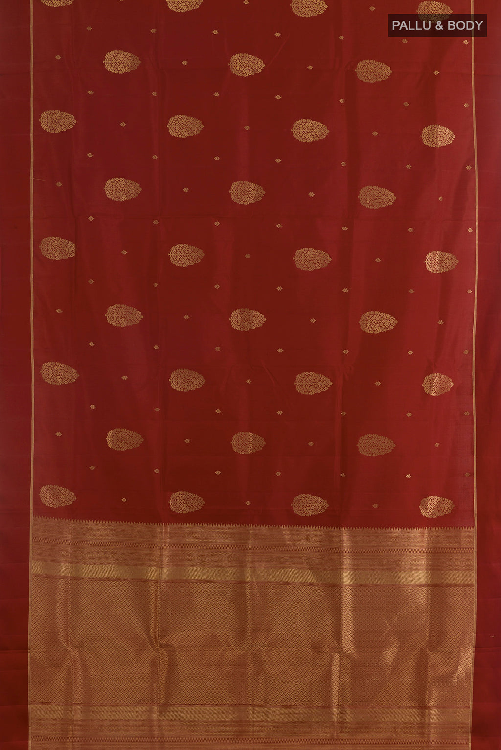 Flat view of Pure Silk Rust Soft Saree with Zari Butta on the body and Zari Border. 