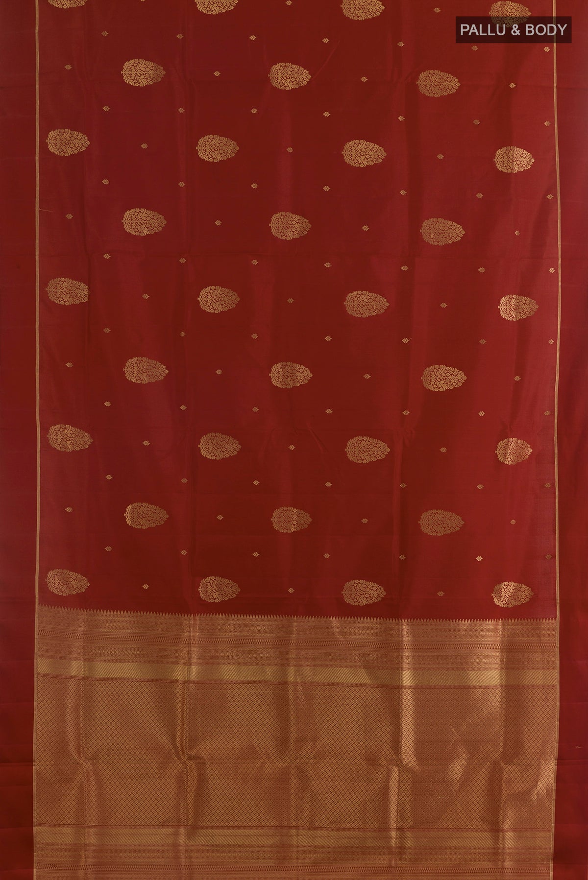 Flat view of Pure Silk Rust Soft Saree with Zari Butta on the body and Zari Border. 