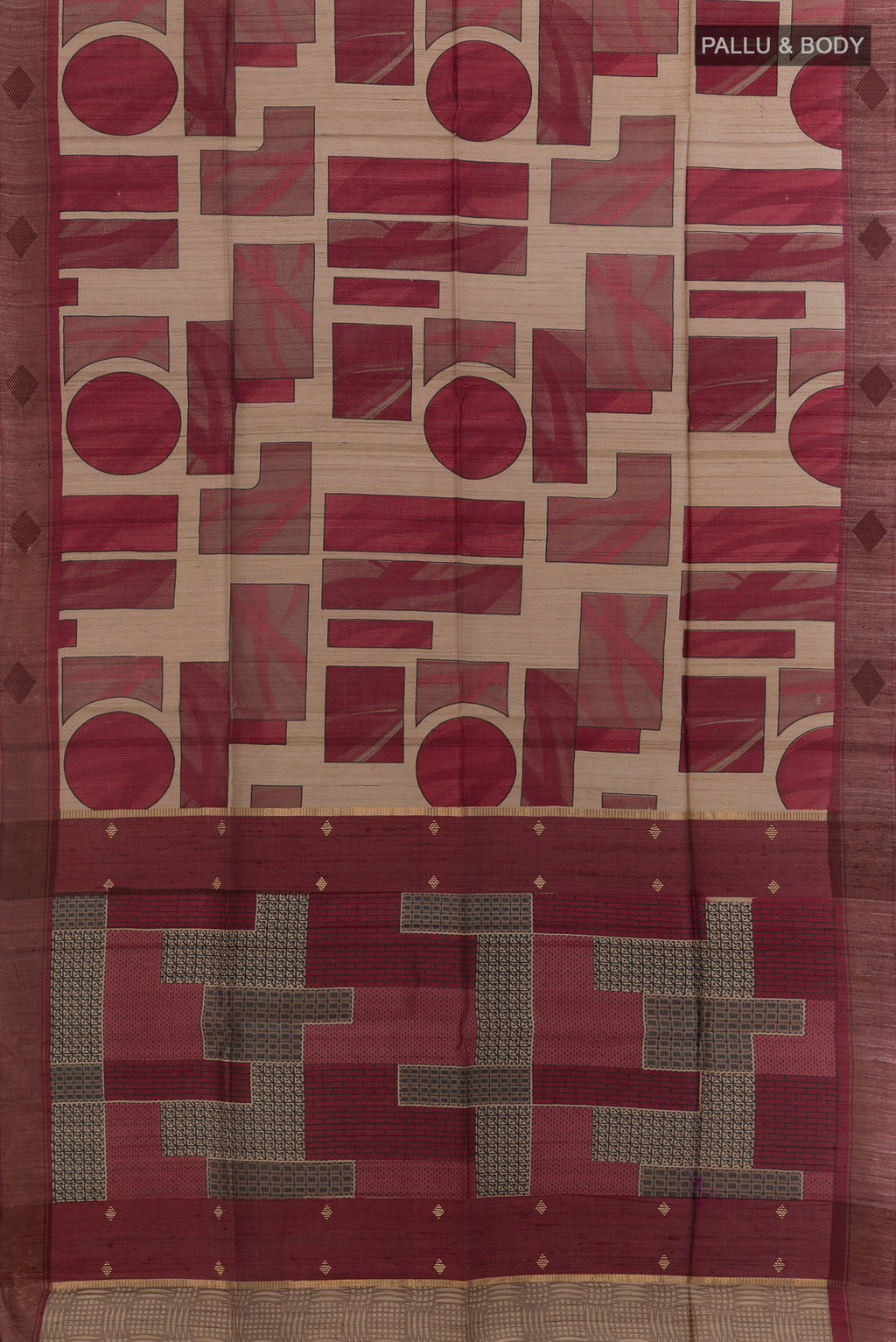 Flat view of Maroon Tussar Saree with Printed design on the body and Zari Border. 