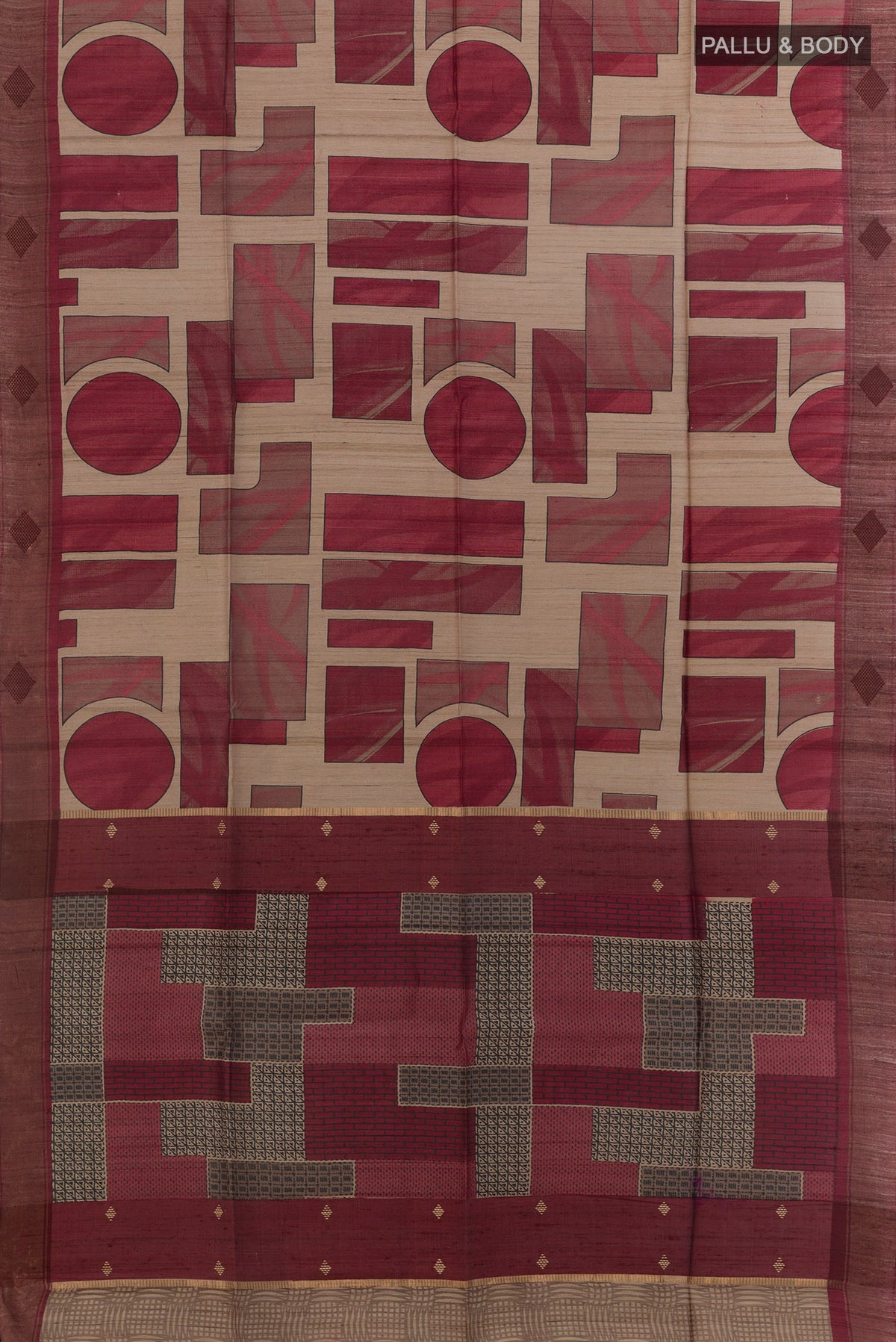 Flat view of Maroon Tussar Saree with Printed design on the body and Zari Border. 
