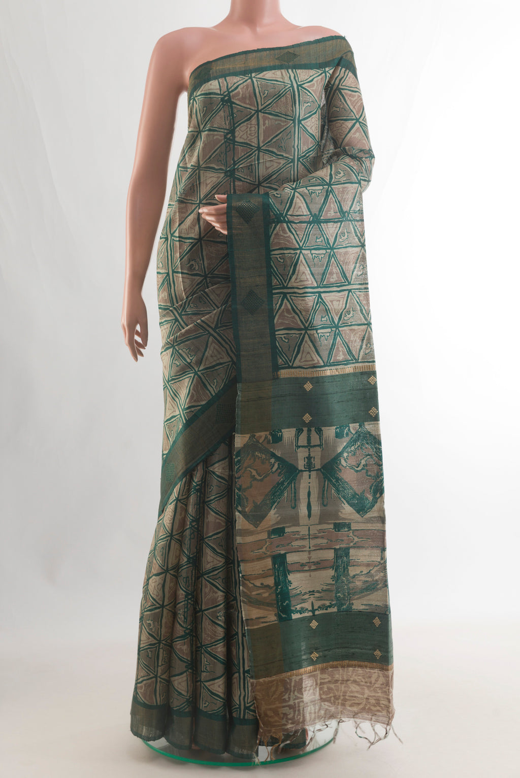 Green Tussar Saree with Printed design on the body and Zari Border.  displayed on a mannequin