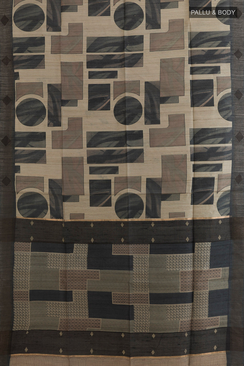 Flat view of Beige Tussar Saree with Printed design on the body and Zari Border. 