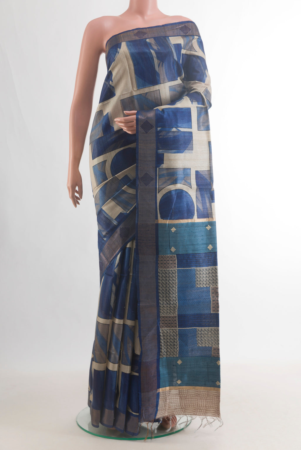 Blue Tussar Saree with Printed design on the body and Zari Border.  displayed on a mannequin
