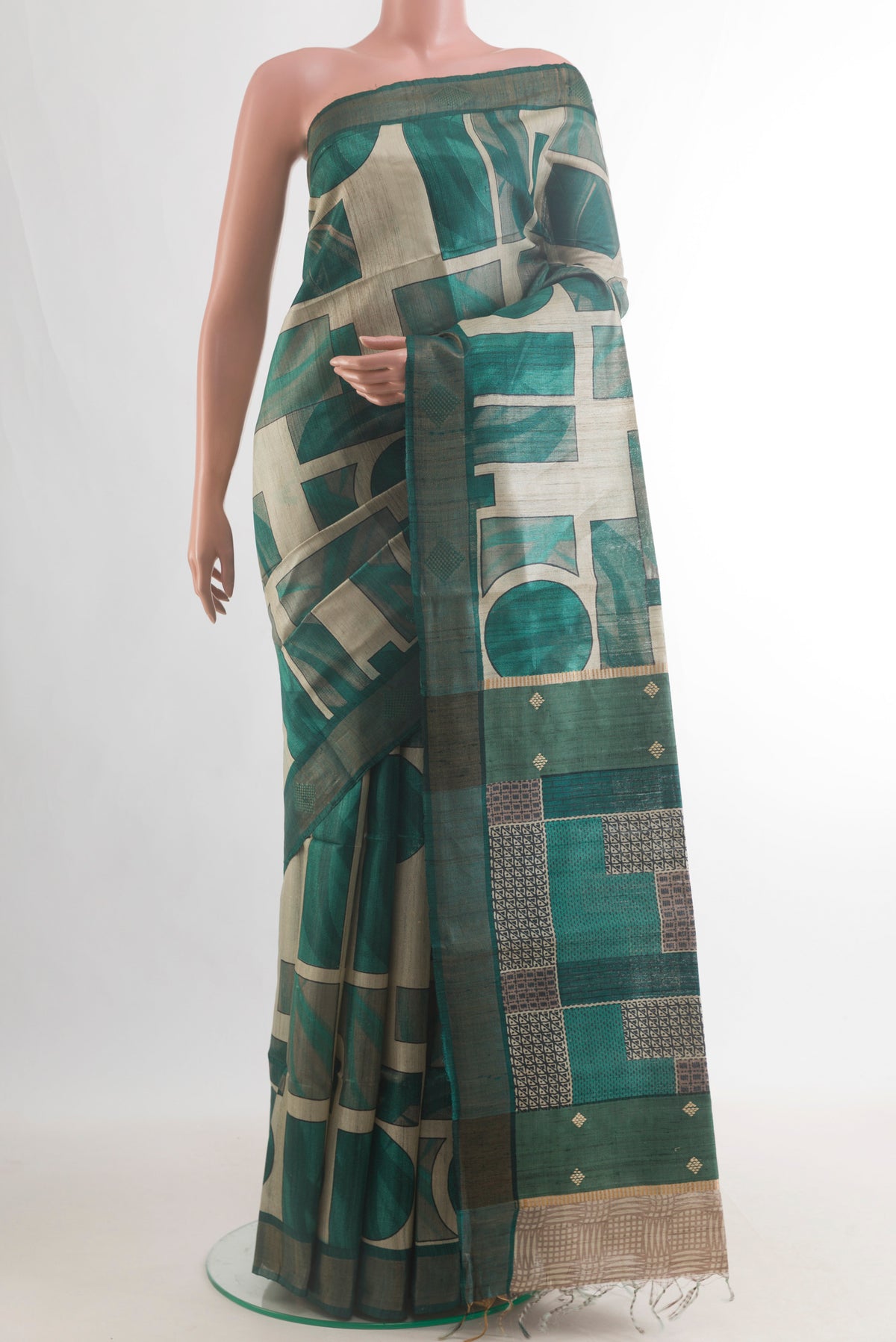 Green Tussar Saree with Printed design on the body and Zari Border.  displayed on a mannequin