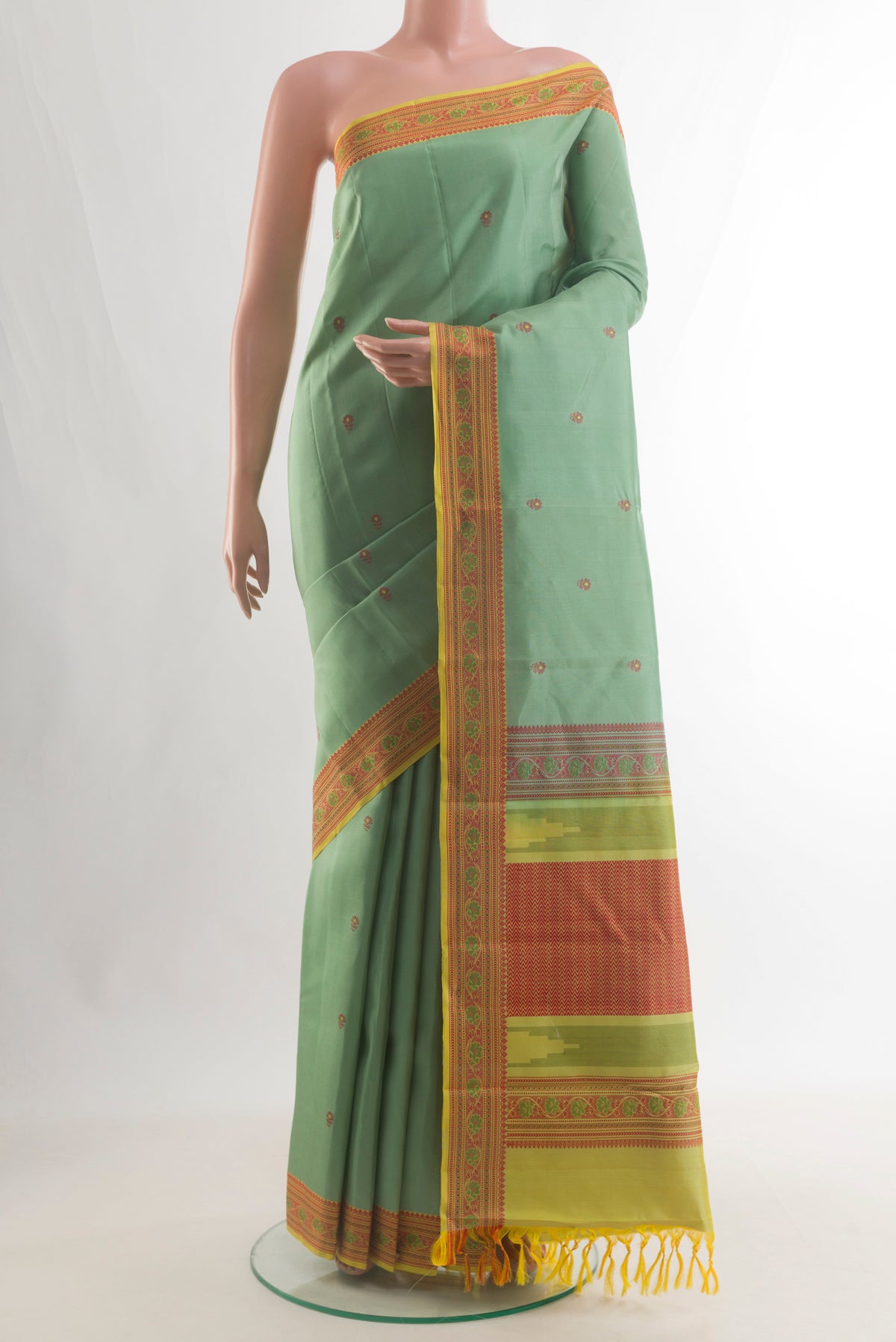 Pure Silk Sage Green Kanchipuram Saree with Thread Butta on the body and Thread Border.  displayed on a mannequin
