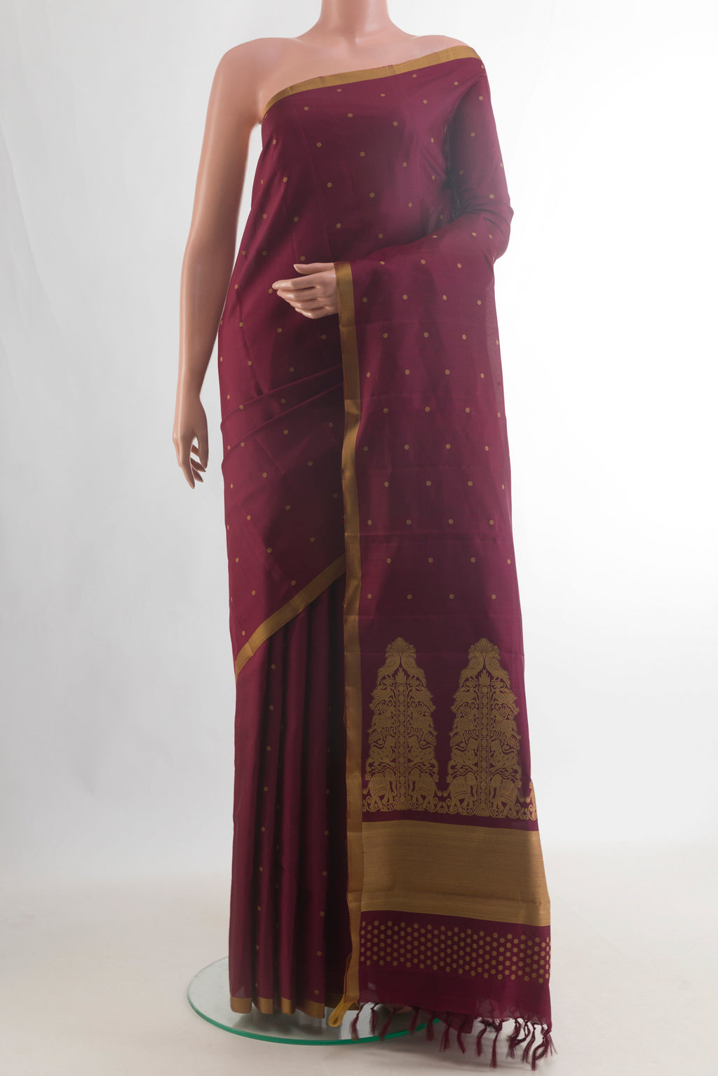 Pure Silk Maroon Kanchipuram Saree with Thread Butta on the body and Plain Border.  displayed on a mannequin