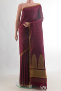 Pure Silk Maroon Kanchipuram Saree with Thread Butta on the body and Plain Border.  displayed on a mannequin