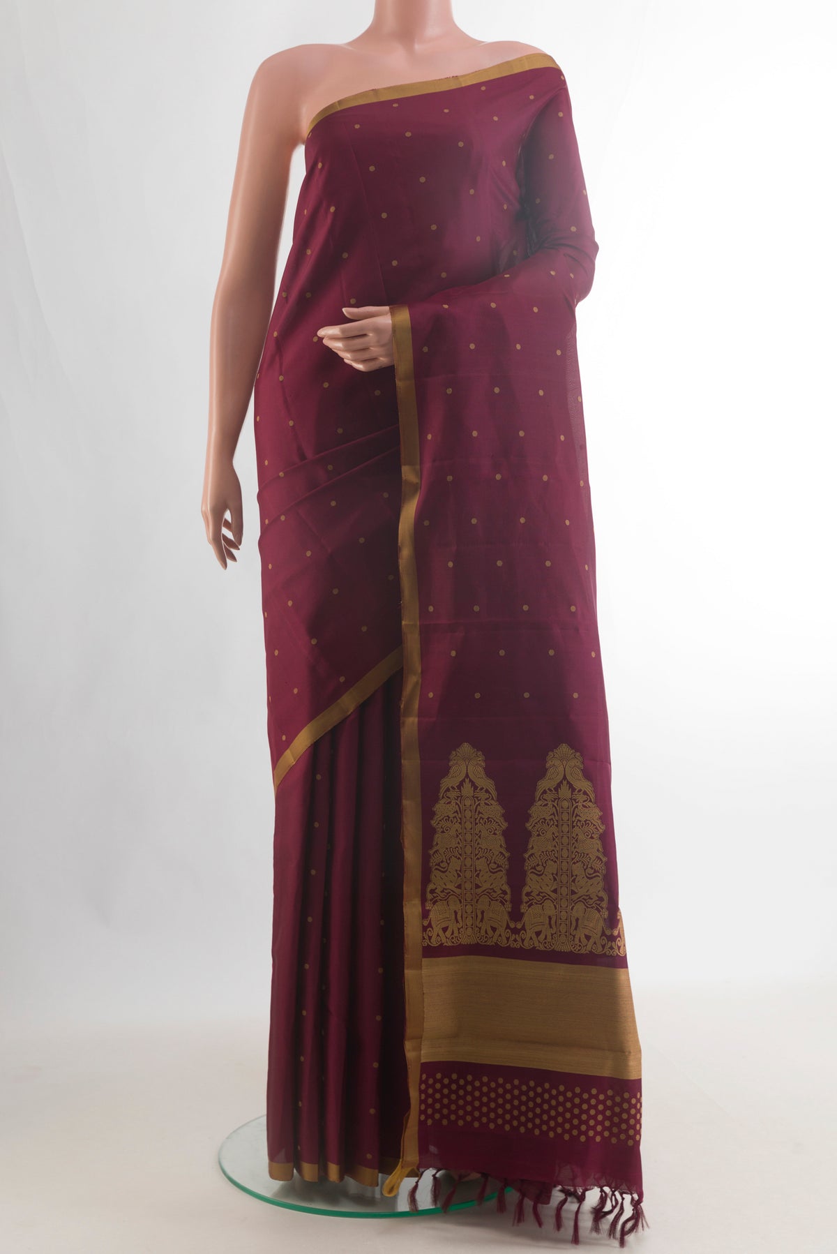 Pure Silk Maroon Kanchipuram Saree with Thread Butta on the body and Plain Border.  displayed on a mannequin